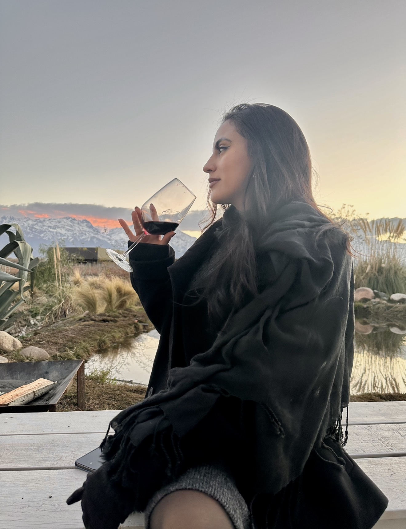 Daiana enjoying a glass of wine at sunset